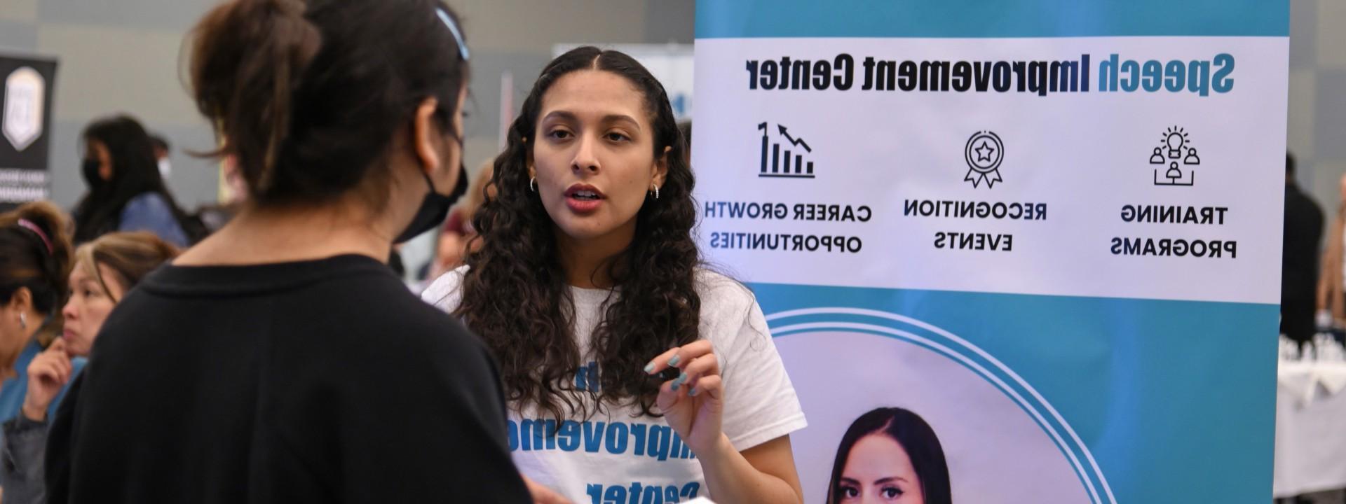 Student speaking with an employer at a career fair