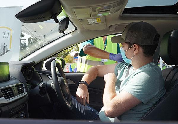 Person receiving vaccine at a drive thru at Cal State LA