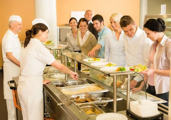 cafeteria workers serving food to people