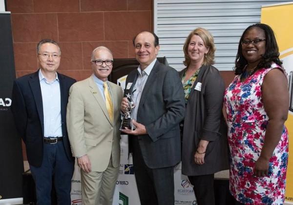 biotech leader, willie zuniga, poses for a group photo