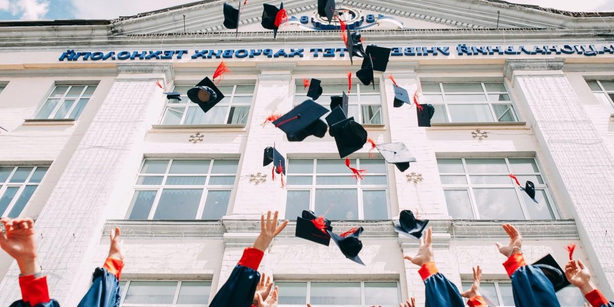 graduation caps being thrown in the air