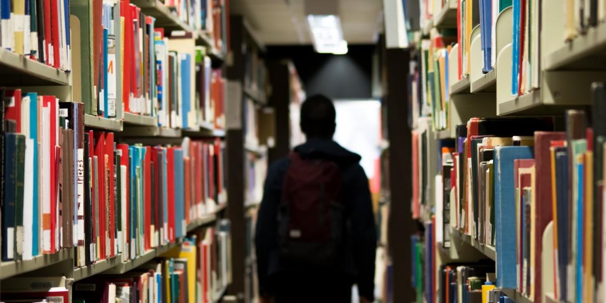 student walking through library