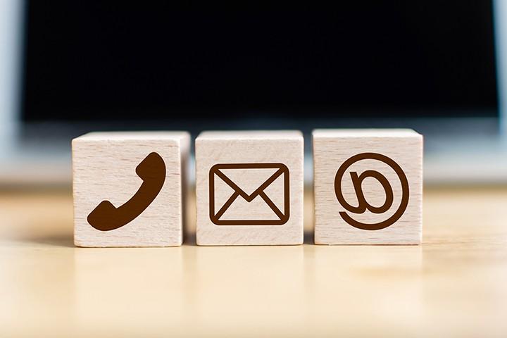 Small wood blocks with icons for email and phone.