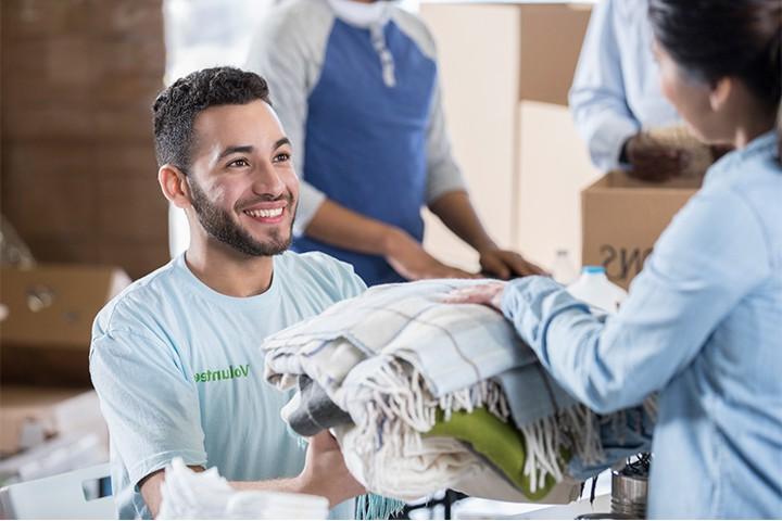 Image of woman donating to social services volunteer