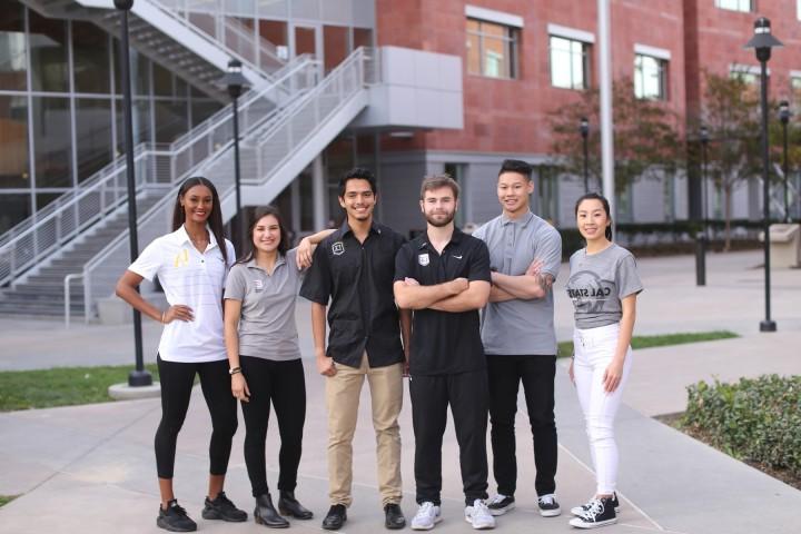 Group of students wearing 加州大学洛杉矶分校 branded clothing standing outsize of La Kretz Hall