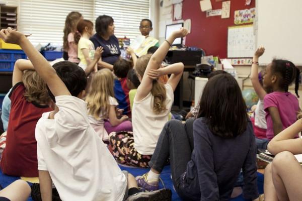 student raising hand in the classroom